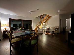 a dining room and living room with a table and chairs at Mazurskie Energie dom ekologiczny całoroczny in Stare Juchy