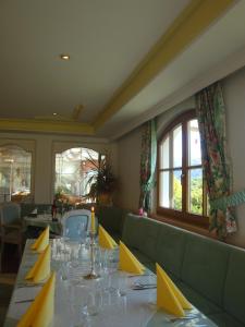 a dining room with a long table with yellow napkins at Hotel White Mountain in Telfes im Stubai