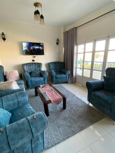 a living room with blue couches and a coffee table at luxor Nile view duplex apartment in Luxor