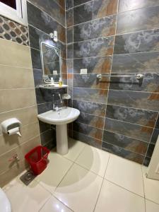 a bathroom with a sink and a mirror at luxor Nile view duplex apartment in Luxor +18 photos