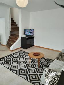 a living room with a couch and a table at Duplex proche du centre-ville in Decize