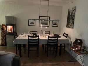 a dining room with a table with chairs and a fireplace at Eksklusiv hytte, Utsikt, ro og høy komfort in Gjøvik +24 photos