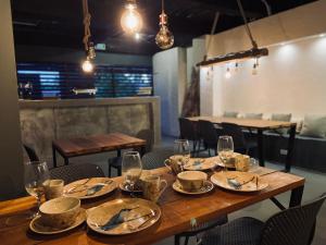 a wooden table in a restaurant with plates and glasses at BHB - ApartaHotel in Leticia