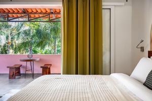 a bedroom with a bed and a large window at Casa Bella Cruz in Cruz de Huanacaxtle +80 photos