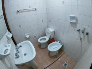 a bathroom with a sink and a toilet and a bidet at Imaynalla Humahuaca Hostl in Humahuaca +22 photos