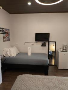 a bedroom with a bed and a flat screen tv at MADRE TERRA in Uvita +68 photos