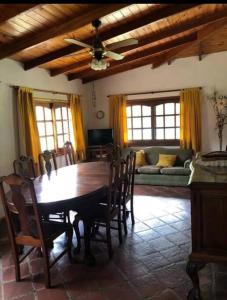 a dining room with a table and chairs and a couch at Casa Quinta para Descansar en Mercedes in Mercedes