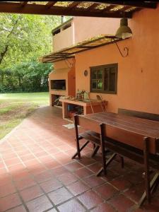 an outdoor patio with a bench and a kitchen at Casa Quinta para Descansar en Mercedes in Mercedes