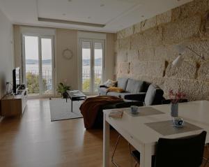 a living room with a couch and a table at Apartamento Miracies in Vigo