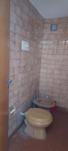 a bathroom with a toilet and a sink at El nuevo amanecer mar de ajó in Mar de Ajó