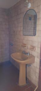a bathroom with a sink and a mirror at El nuevo amanecer mar de ajó in Mar de Ajó