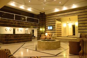 a lobby of a hotel with a reception desk and a waiting room at Carlton Tower Hotel Lahore in Lahore