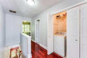 a kitchen with white walls and white cabinets at Unwind & Relax at Legacy Estates in Stone Mountain +35 photos