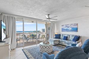 a living room with a couch and a view of the ocean at Magnolia House 307 At Destin Pointe Resort in Destin