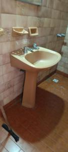 a bathroom with a sink and a mirror at El nuevo amanecer mar de ajó in Mar de Ajó