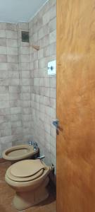 a bathroom with a toilet and a sink at El nuevo amanecer mar de ajó in Mar de Ajó