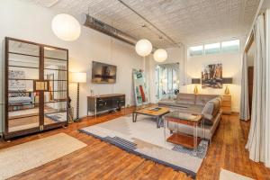 a living room with a couch and a table at High-Design Downtown Loft in Asheville