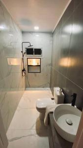 a white bathroom with a toilet and a sink at La Perla in Nueva Helvecia +17 photos