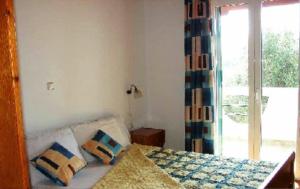 Postel nebo postele na pokoji v ubytování Olympia Paxos Villas & Apartments