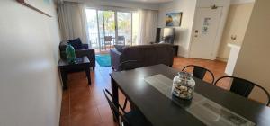 a living room with a table and chairs and a living room at Bayview Waters Apartments in Gold Coast
