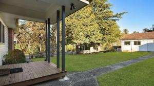 a house with a wooden porch with a yard at Balgownie Cottage in Blackheath +3 photos