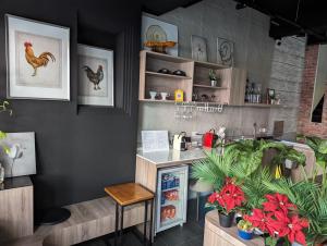 a restaurant with a counter with chickens on the wall at 蘆思特六合民宿 in Kaohsiung
