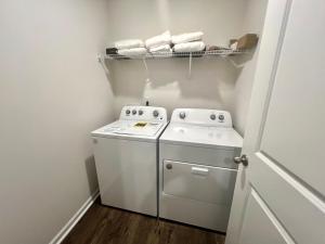 a small laundry room with a washer and dryer at Brand New Home in Moor in Moore