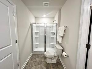 a small bathroom with a toilet and a shower at Brand New Home in Moor in Moore +18 photos