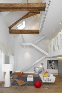 sala de estar con sofá blanco y escaleras en Le Loft d'Annecy - Vision Luxe en Annecy