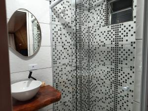 a bathroom with a sink and a glass shower at Chalé das Princesas in Campos do Jordão +8 photos