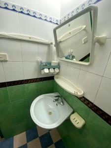a bathroom with a sink and a mirror at Alex Ha Long Hotel in Ha Long