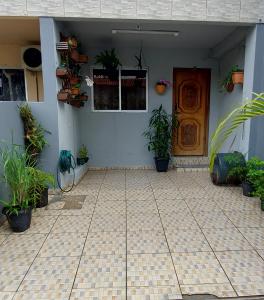 Una habitación con una puerta y plantas en macetas. en cantinho da lily, en Balneário Camboriú