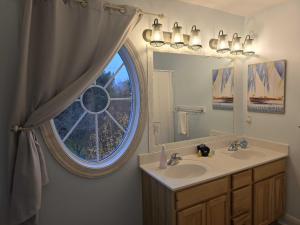 a bathroom with a sink and a window at Downtown Oasis by the Bay in Traverse City +142 photos