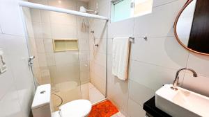 a bathroom with a shower and a toilet and a sink at Pousada recanto porto tropical in Sirinhaém +23 photos
