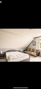 a bedroom with a large white bed and a window at Øyperlen in Hernar +4 photos