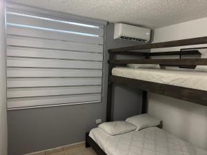 a bedroom with two bunk beds and a window at Private apartment near sju Solar Battery in Carolina +17 photos