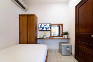 Postel nebo postele na pokoji v ubytování Saigon Park Hotel Dist 1
