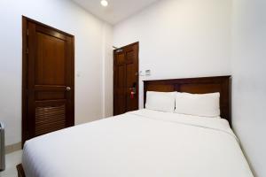 Postel nebo postele na pokoji v ubytování Saigon Park Hotel Dist 1