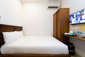 Postel nebo postele na pokoji v ubytování Saigon Park Hotel Dist 1