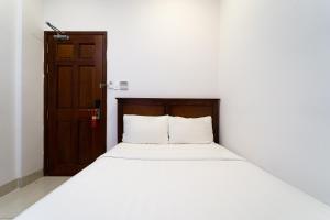 Postel nebo postele na pokoji v ubytování Saigon Park Hotel Dist 1