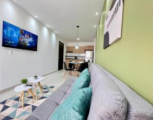 a living room with a couch and a tv on a wall at 201S Apartamento de ensueño in Vallecito