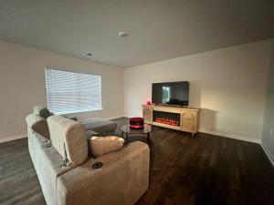 a living room with a couch and a flat screen tv at Home in Moor in Moore
