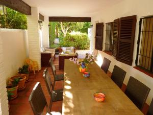 a patio with a wooden table and chairs at Luxurious Villa in Marbella with Swimming Pool in Marbella