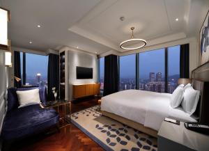 a bedroom with a large bed and a large window at The Lixury Hotel, in The Unbound Collection by Hyatt - Liberation Square in Chongqing