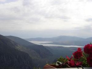 a view of a valley with a lake and mountains at Sun View Guesthouse in Delfoi