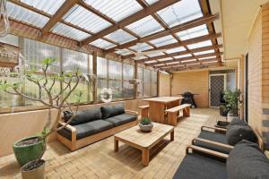 a living room with a couch and a table at 3 bedroom, pet friendly home CBD in Warrnambool