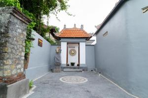 an entry to a house with a tile roof at kenanga Villa Ubud in Ubud