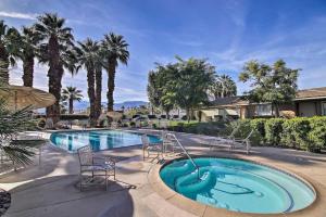 a large swimming pool with chairs and a swimming pool at Upscale mid century on the green w Private Hot Tub in Palm Desert