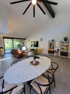 a living room with a white table and chairs at Upscale mid century on the green w Private Hot Tub in Palm Desert