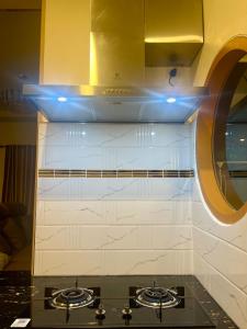 a kitchen with two burners on top of a stove at N&N Home&Resort in Ratchaburi +40 photos